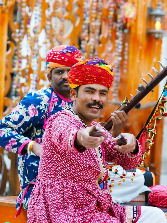 Categories Traditional Rajasthani musicians play folk music with vibrant costumes and instruments.